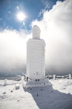 A frosty mound on a summit of Snezka mountain, located on borders with Poland. Winter picture of Czech national park called Krkonose.