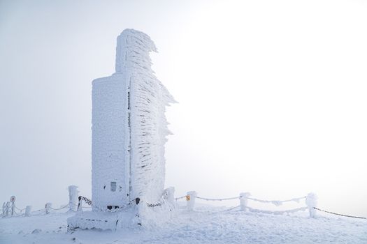A frosty mound on a summit of Snezka mountain, located on borders with Poland. Winter picture of Czech national park called Krkonose.