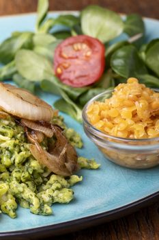 bavarian spinach spaetzle on a blue plate