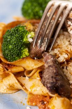 tagliatelli with steak slices on a plate