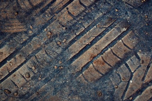 abstract background or texture imprint of rubber tread pattern on old asphalt