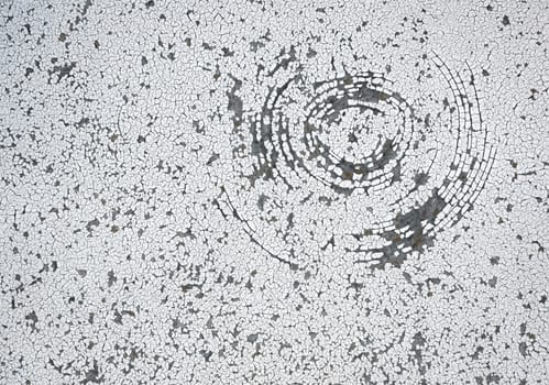 background or texture circular cracked white paint on cardboard