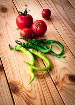 food background tomatoes and peppers on wooden table