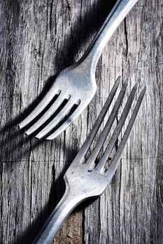 background two old forks on a gray plate