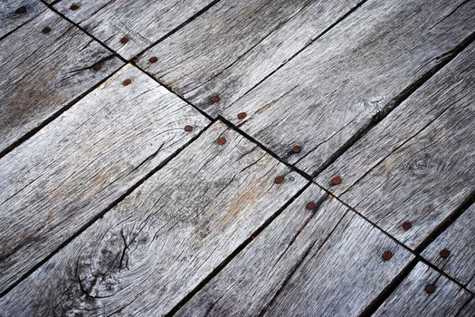 background or texture Detail of an old wooden slab floor with nails