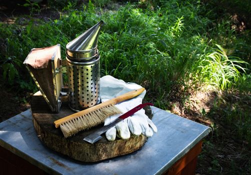 Beekeeping background with smoker and gloves and spacer