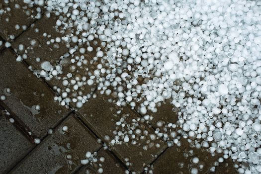 seasonal background ice hail on concrete pavement