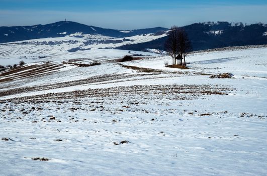 seasonal background winter landscape with gradually melted snow