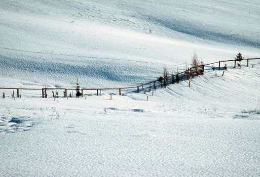 seasonal background snowy meadow with fence