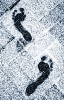 seasonal background bare feet in the snowy sidewalk