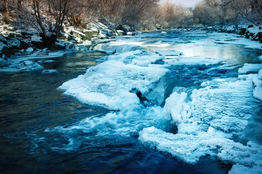 landscape seasonal background small winter frozen river with cascades