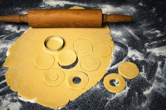 food background wood roller and dough prepared for cakes