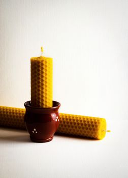 background still life with two beeswax candles
