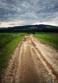nature landscape background muddy road to the clouds