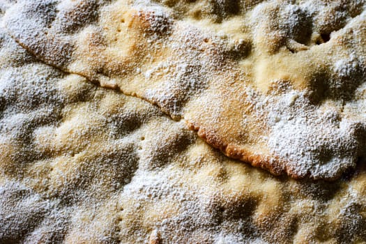 food background the surface of the cake sprinkled with powdered sugar