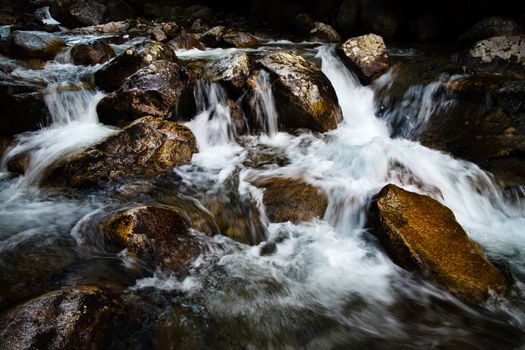 nature background wild mountain stream between stones