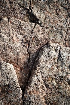 background or texture a brown granite block with a crack