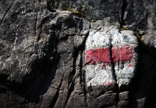 background or texture red tourist sign on limestone rock