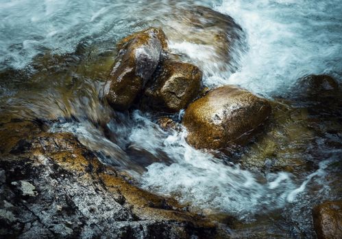 nature background three stones in the wild river