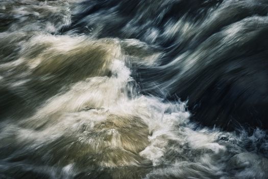 abstract nature background dark ripples on a wild river