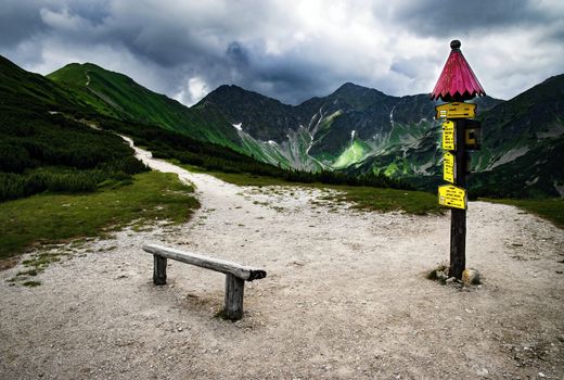 nature seasonal background mountain landscape with a bench and a pointer