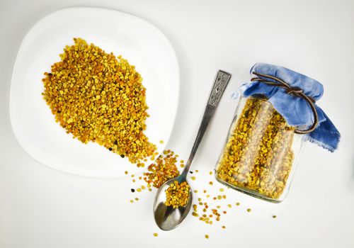 food background Still life of pollen beads with a plate and spoon