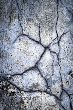 abstract dark background or texture Detail of old blue plaster with cracks