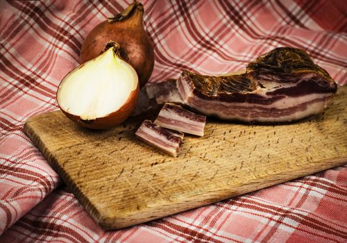 background food bacon with onion on wooden board