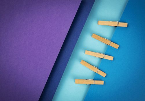 abstract background composition of colored papers and clothes pins