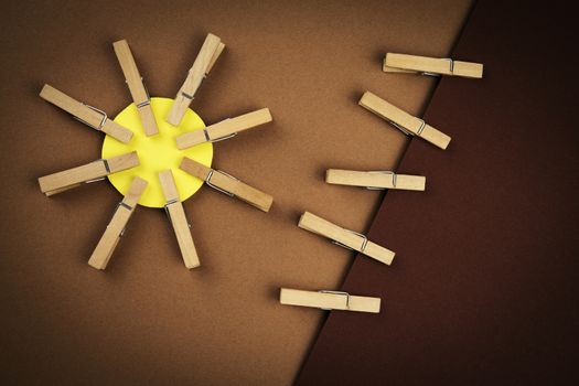 creative background abstract sun with wooden pegs on clothes