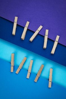 abstract background wooden pins attached to blue paper