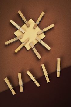 abstract composition with brown colored paper wooden pins