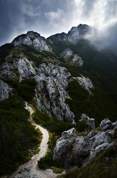 nature seasonal background dark clouds above the limestone mountains