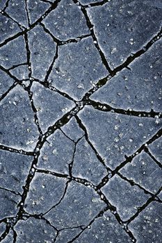 background or texture cracks on a dark asphalt surface