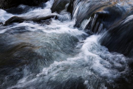 nature background streams in a cold wild river