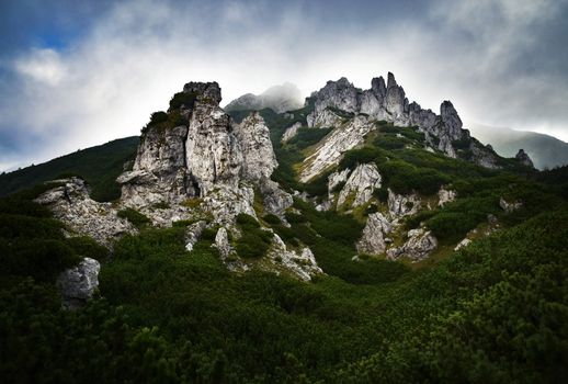 lanscape background a rocky town in the mountains covered with fog