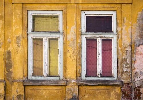 background two old windows on a yellow old house