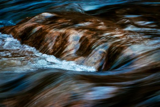 abstract nature background blurred cascades on the autumn river
