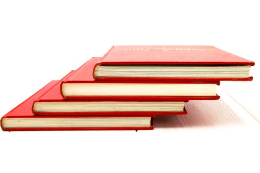 Red books flip over on a floor with white background