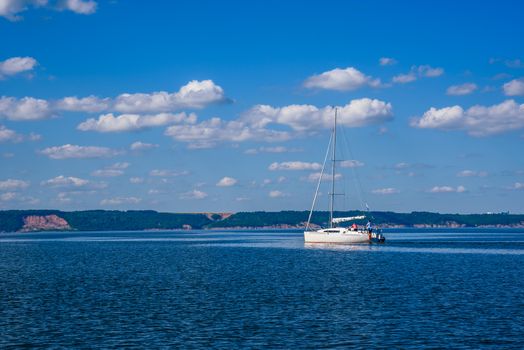 White Sailing Boat on the River at Cloudy Day.