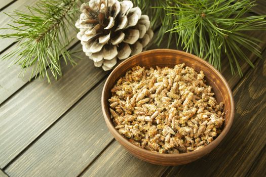 Bowl with pine buds for treating colds. Pine buds. Herbal medicine.