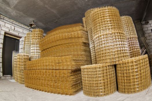 Production of fiberglass mesh reinforcement for construction work.