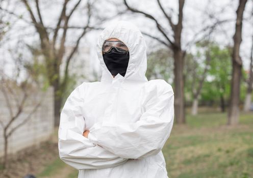 Woman in black mask and white protective suit