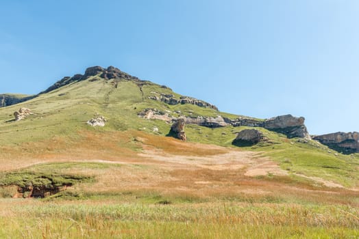 A mountain landscape, with rock formations and golden grass fields, in Golden Gate