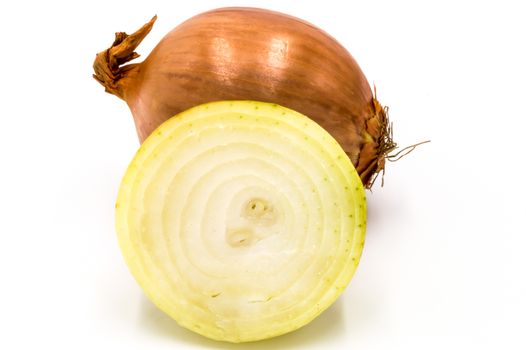 Fresh yellow onion cut in half and whole isolated on white background