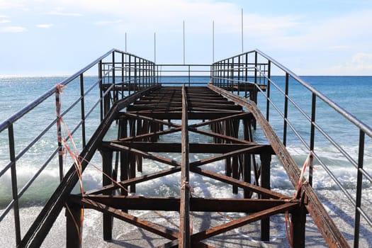 Hard rust pier construction on sea beach