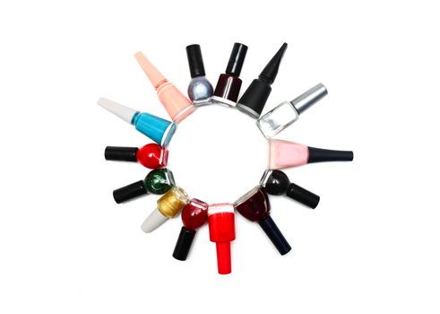 nail polish bottles in a circle over white