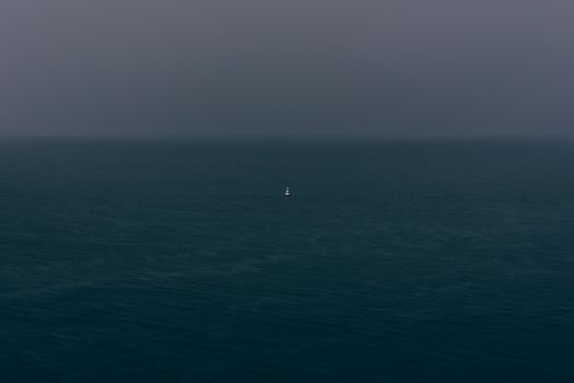 buoy in river at the rainy, overcast day