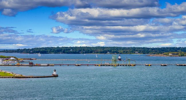 Small lighthouses on rocky points in the harbor near Portland, Maine