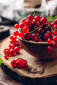 Fresh picked red currants in wooden bowl